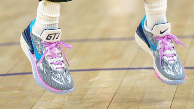 View of Jordan Poole's grey and pink Nike shoes.
